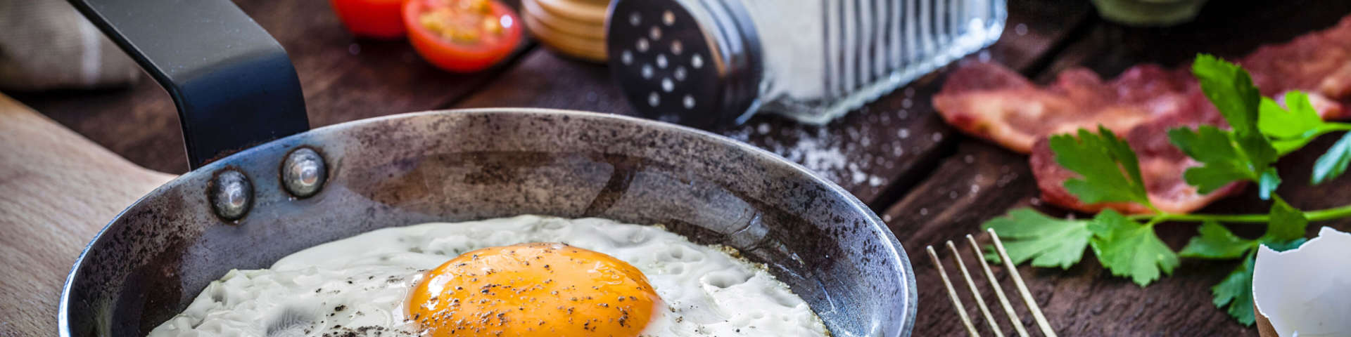 A sunny side up egg in a frying pan.